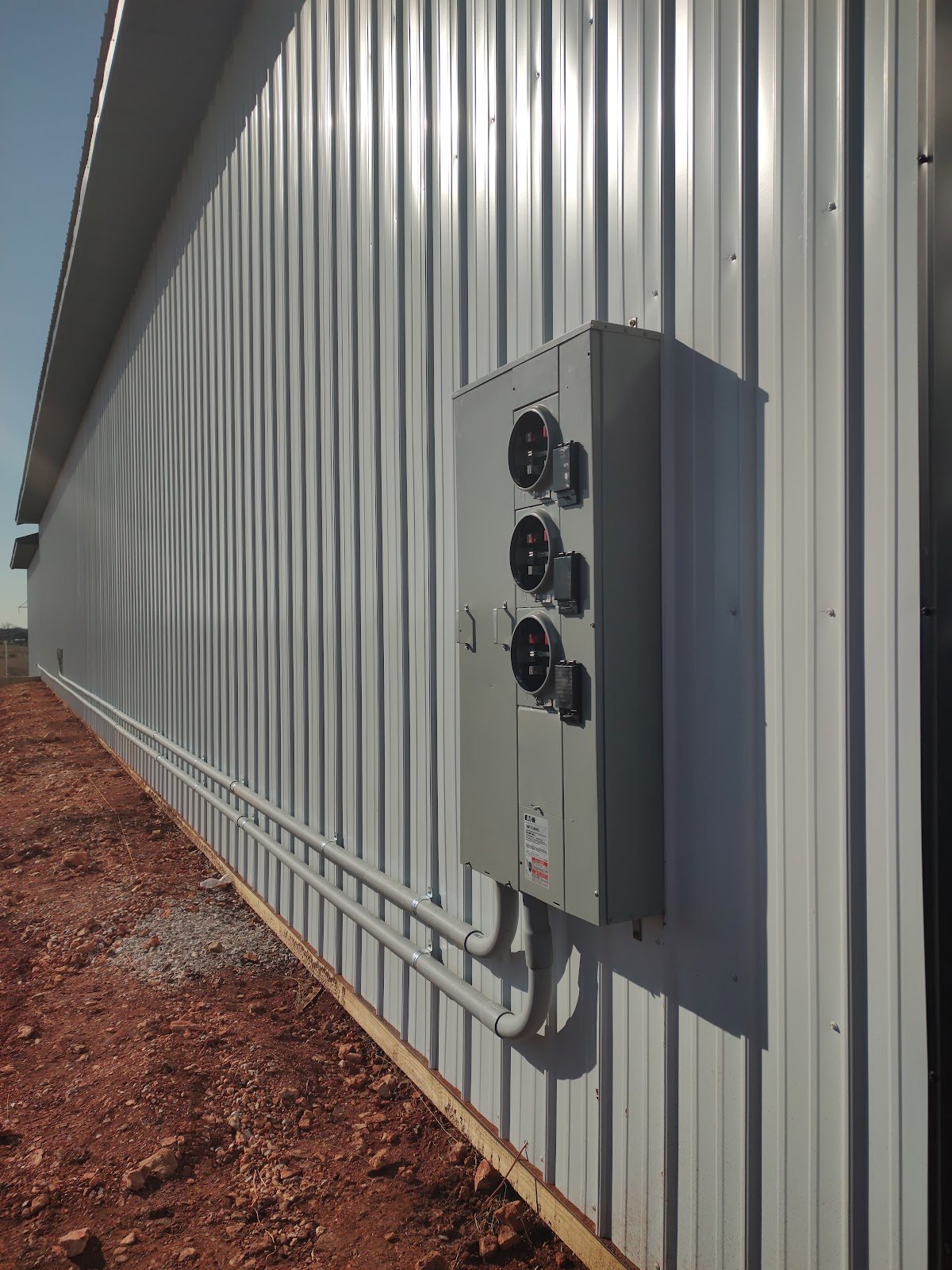 Meter bank and conduit along a new commercial building