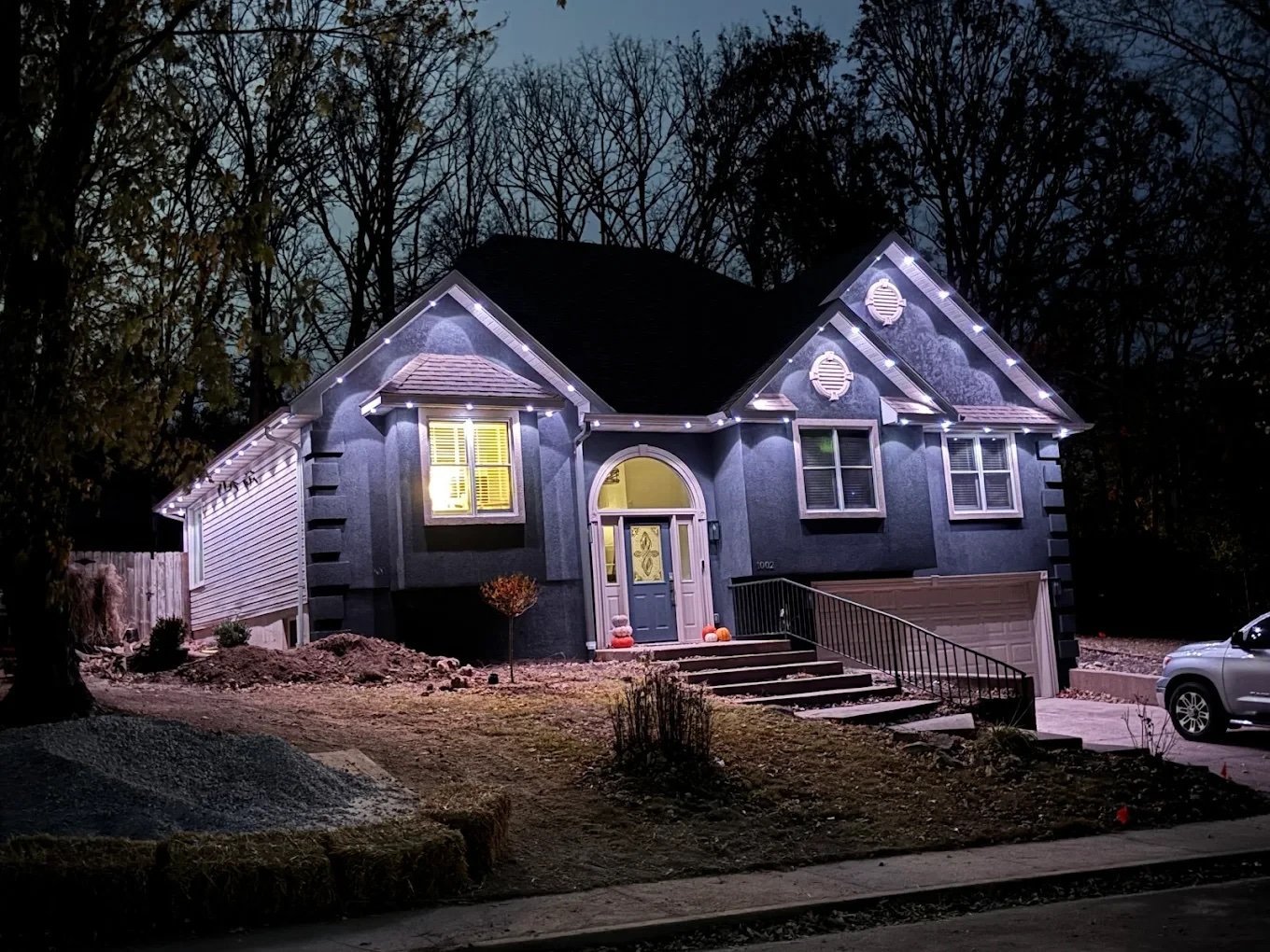 Home lit up at night with exterior lighting installed by Voltec Electric