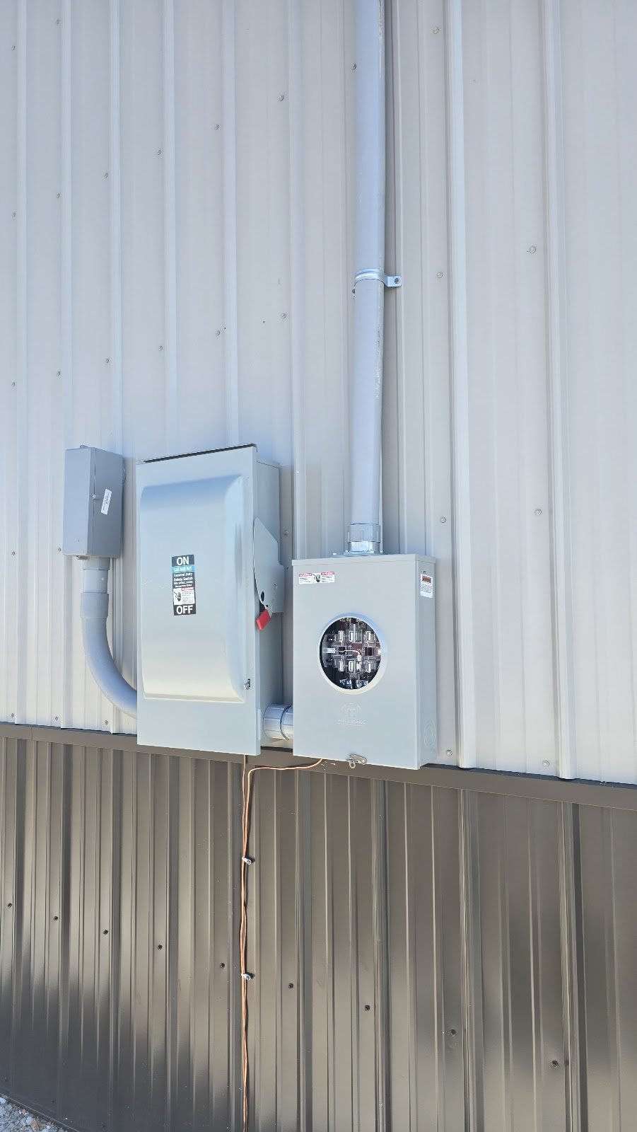 Meter base and disconnect on a metal building